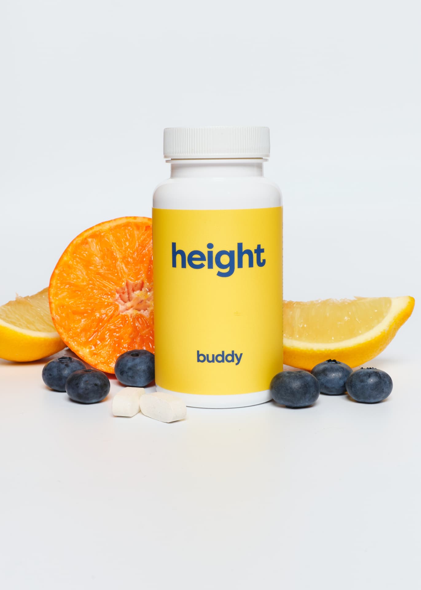 Buddy Kids Growth Support bottle surrounded by fresh fruit