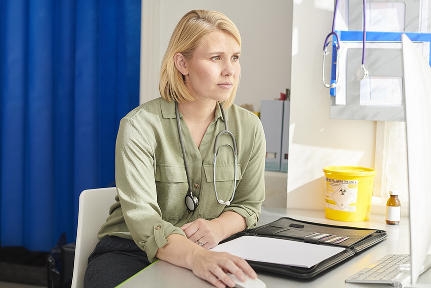 A healthcare professional in a consultation room
