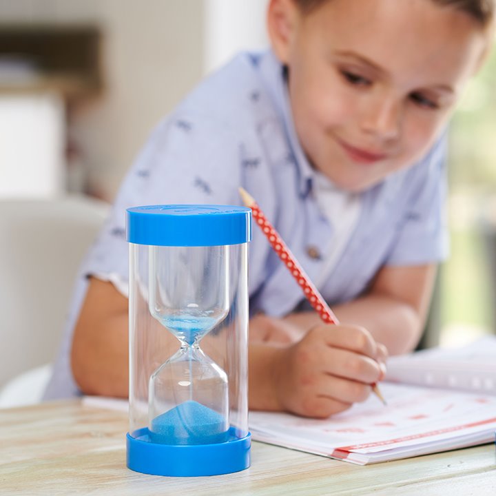 A child working beside a blue sand timer